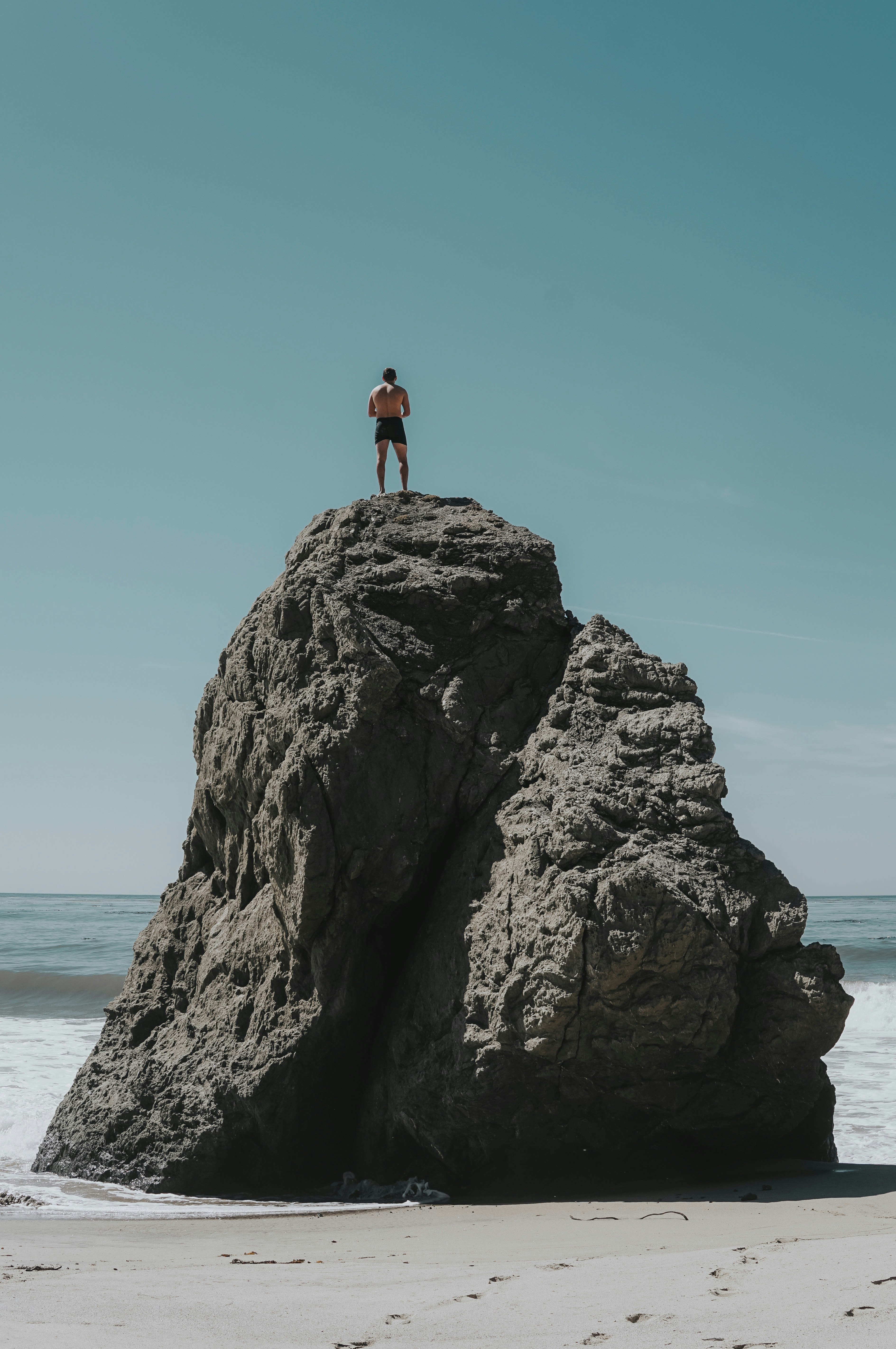 person standing at rock formation
