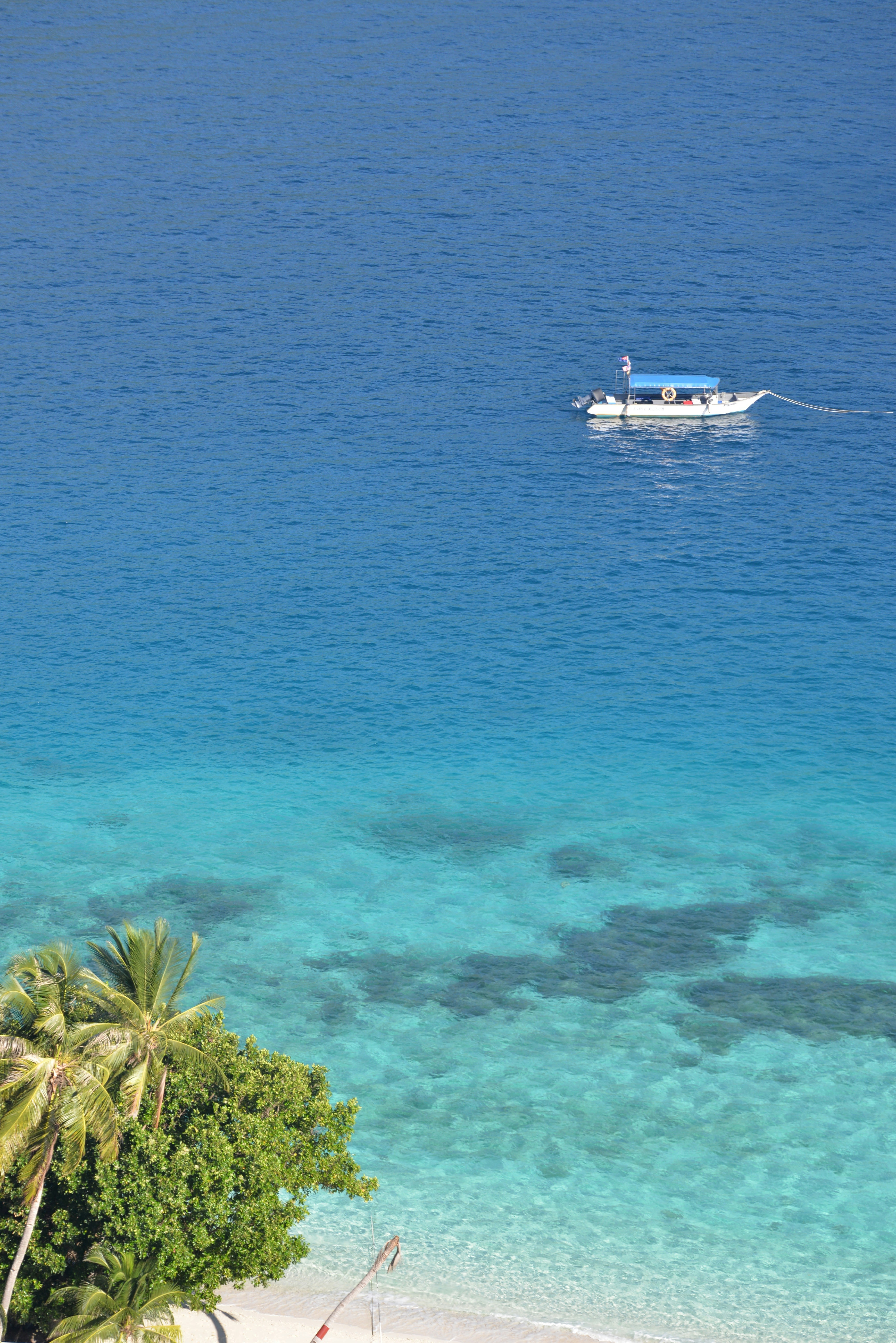 white boat on blue sea during daytime