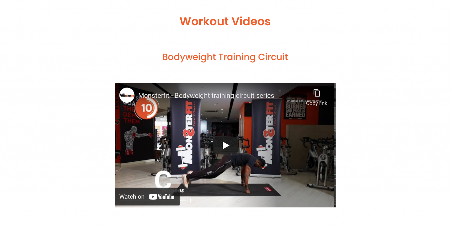 four boys laughing and sitting on grass during daytime