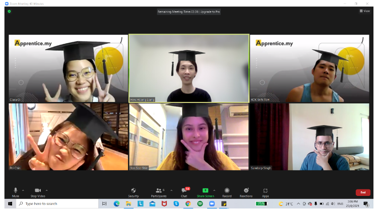 four boys laughing and sitting on grass during daytime