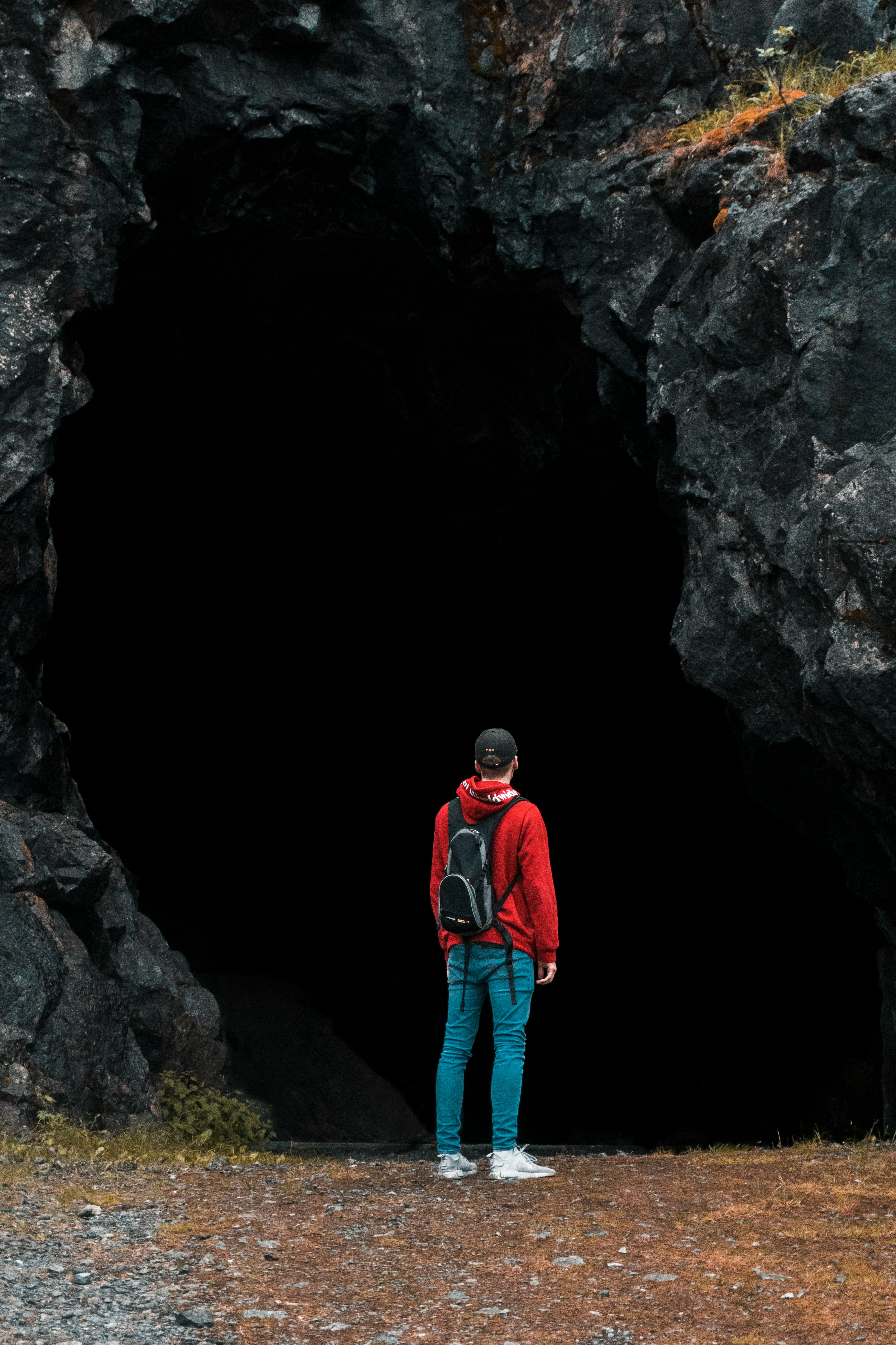 a person standing in front of a cave