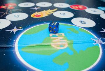 A blue dice on a game board

AI-generated content may be incorrect.