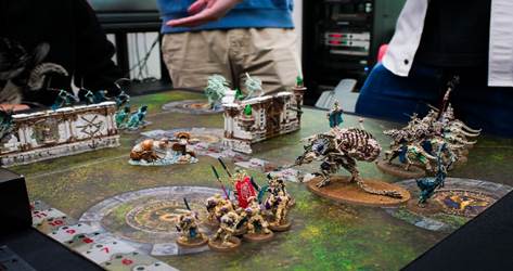 A board game with a group of people standing around

AI-generated content may be incorrect.