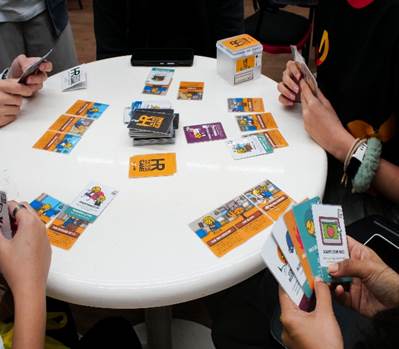 A group of people playing cards on a table

AI-generated content may be incorrect.