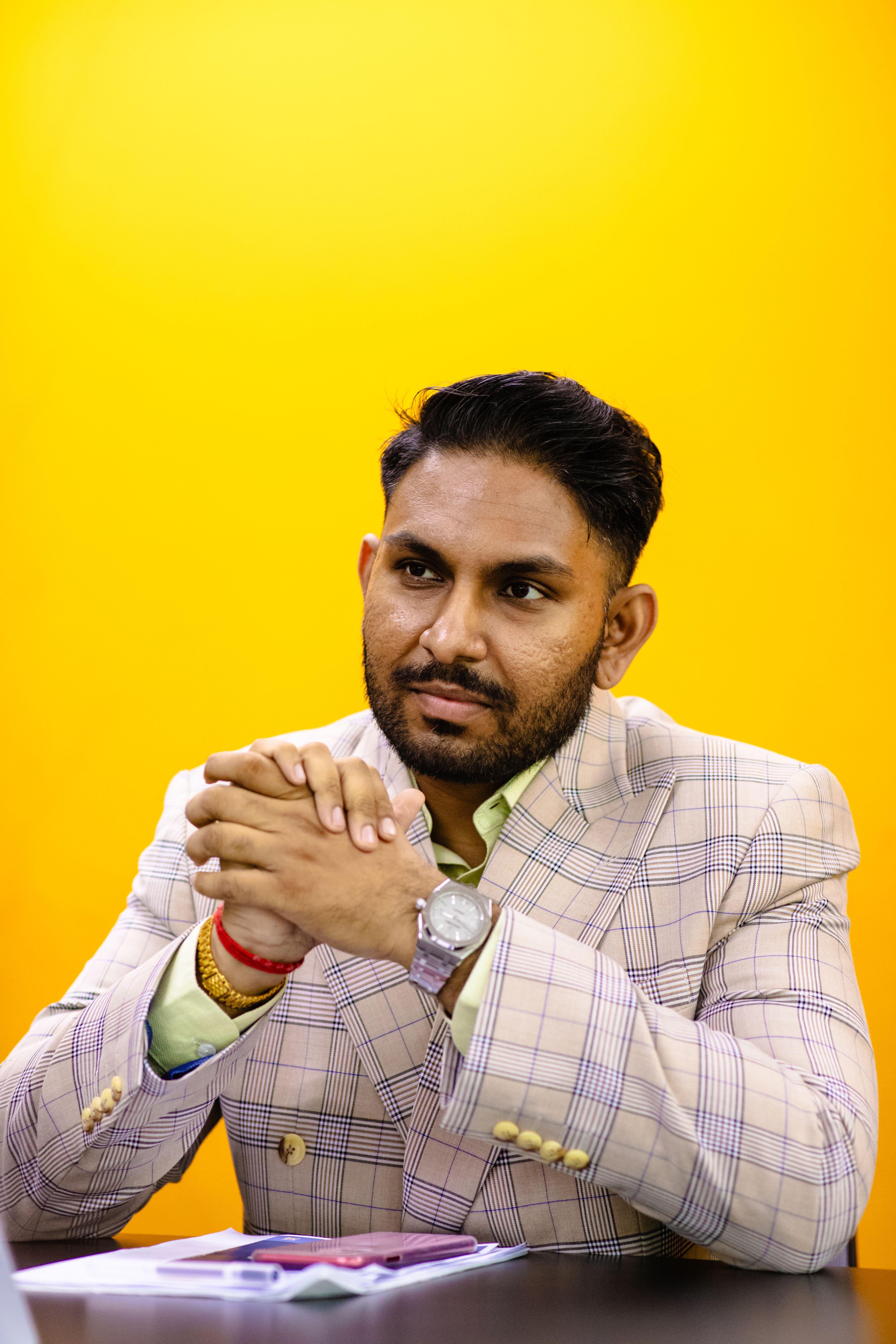 A person sitting with his hands together

AI-generated content may be incorrect.