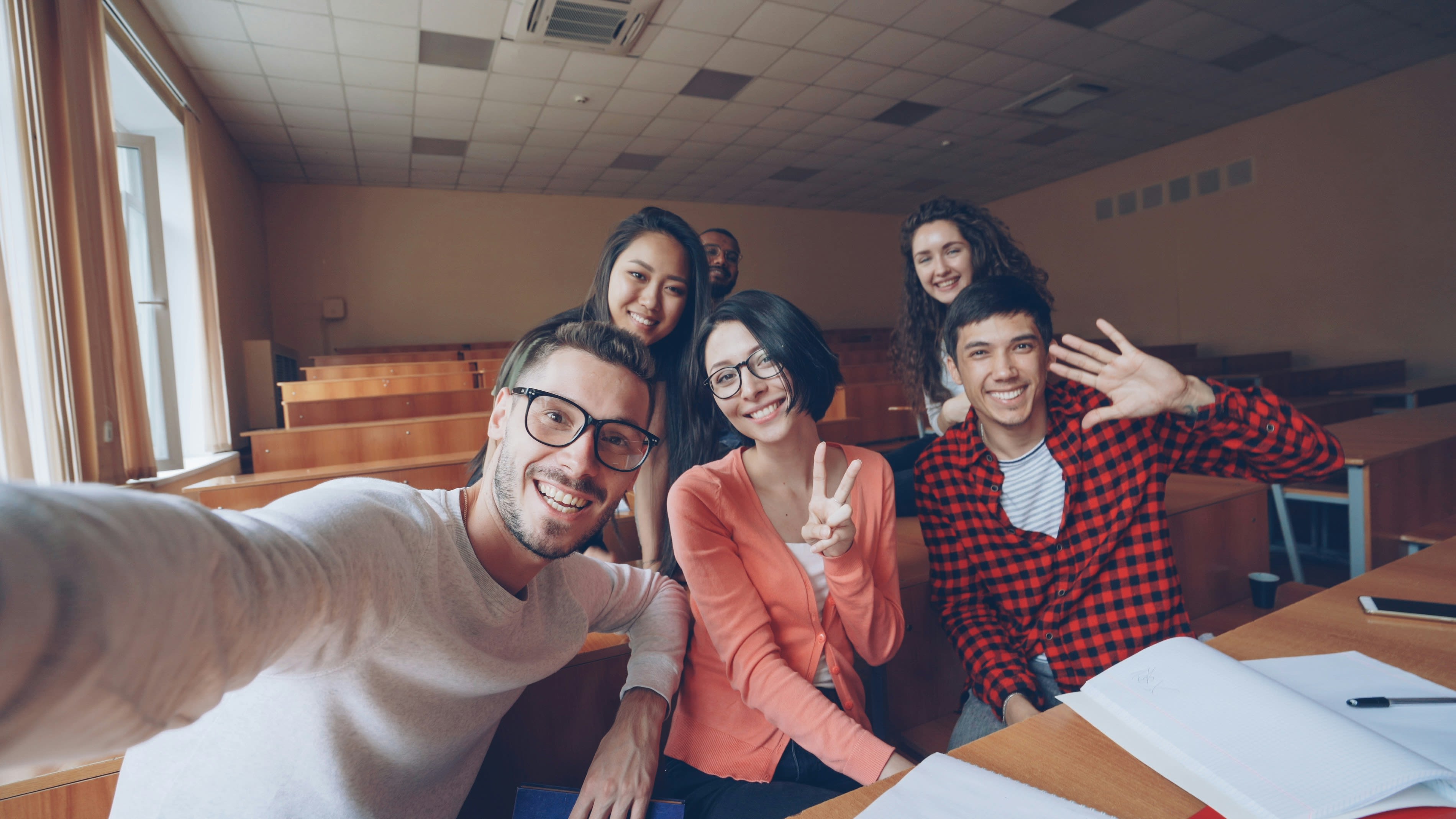 Group of students taking a selfie in a classroom