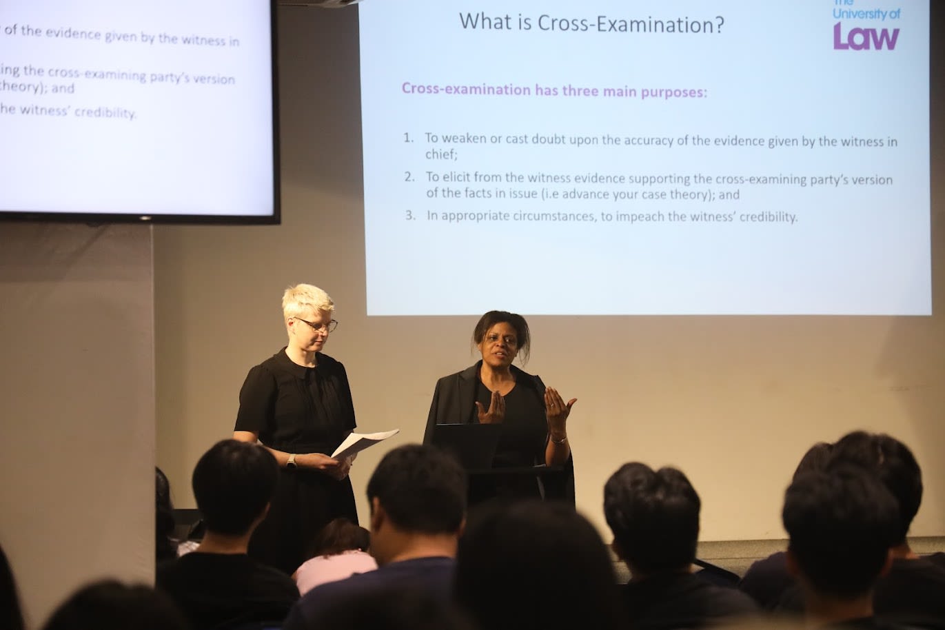 a woman standing in a kitchen next to a man
