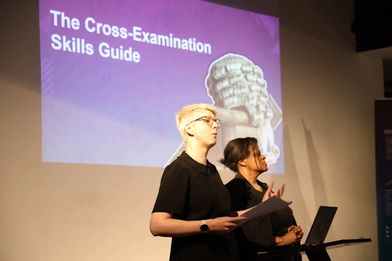 a woman sitting at a table with a piece of paper in front of her